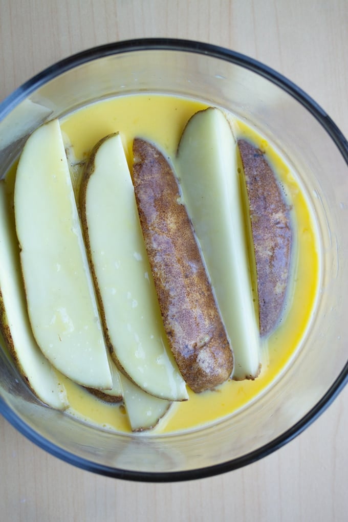 cut russet potatoes in egg and milk