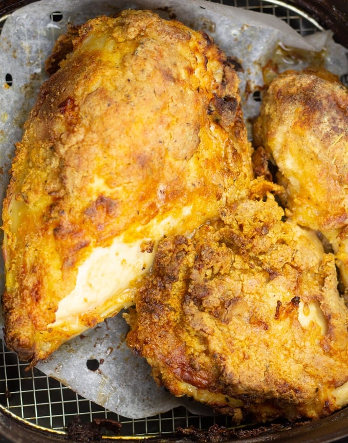 fried chicken pieces in air fryer basket