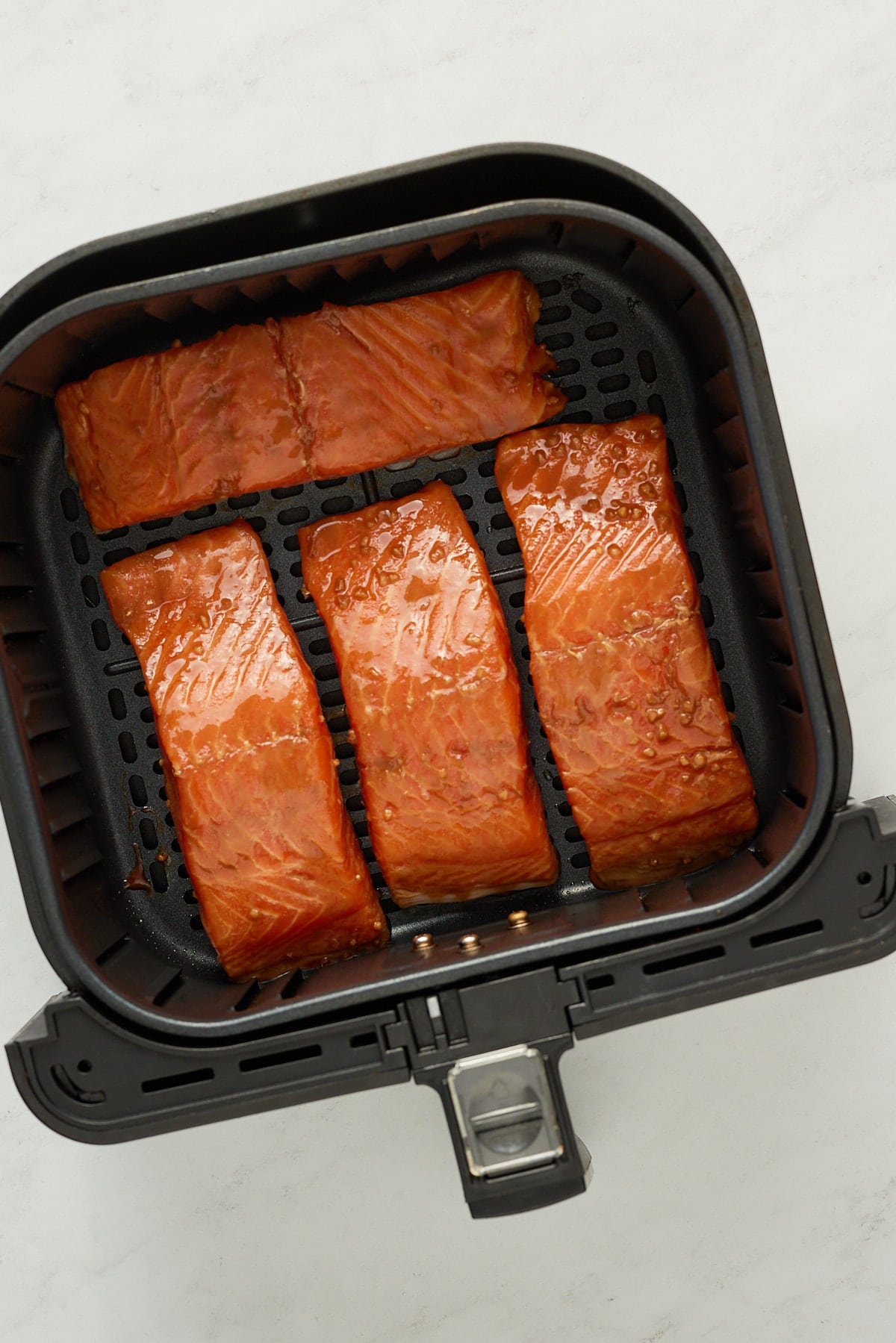 raw salmon in air fryer basket