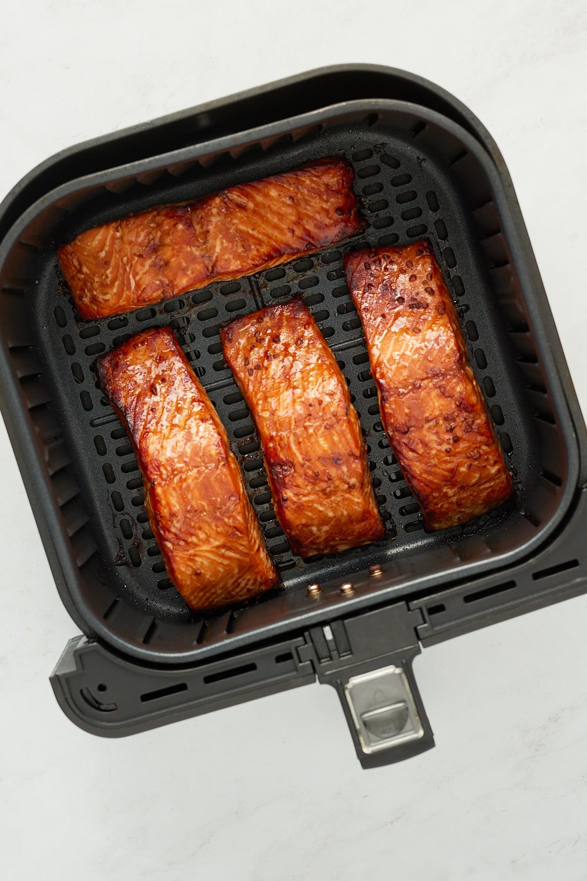 cooked air fryer salmon in air fryer basket