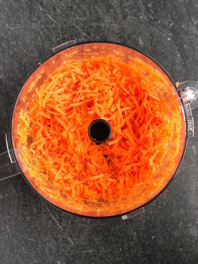 grated carrots in food processor bowl