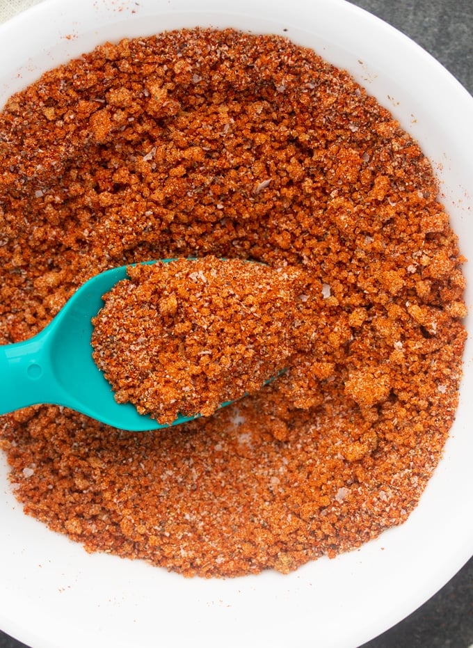 bbq seasoning in a bowl, mixed, with a spoon in the middle