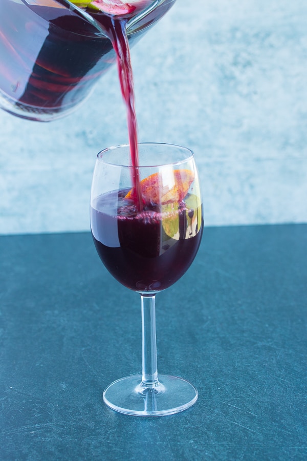 easy red Sangria being poured into a tall glass