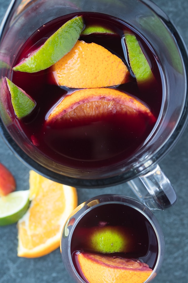 easy red sangria in a pitcher and glass with citrus showing