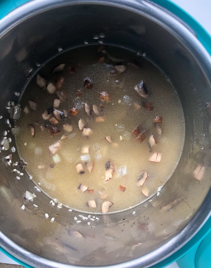 chicken broth and rice and mushrooms in instant pot