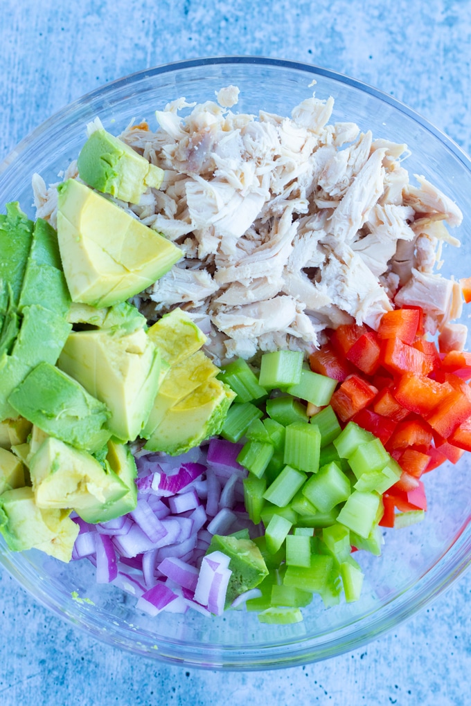 rotisserie chicken salad ingredients laid out in a bowl