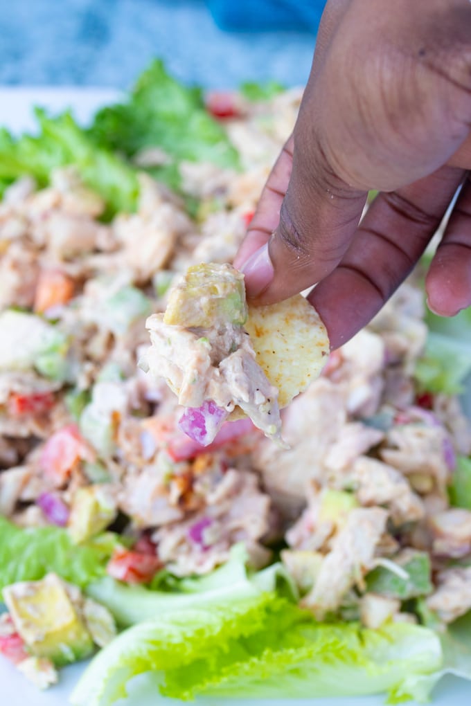 rotisserie chicken salad on a chip being picked up by a hand