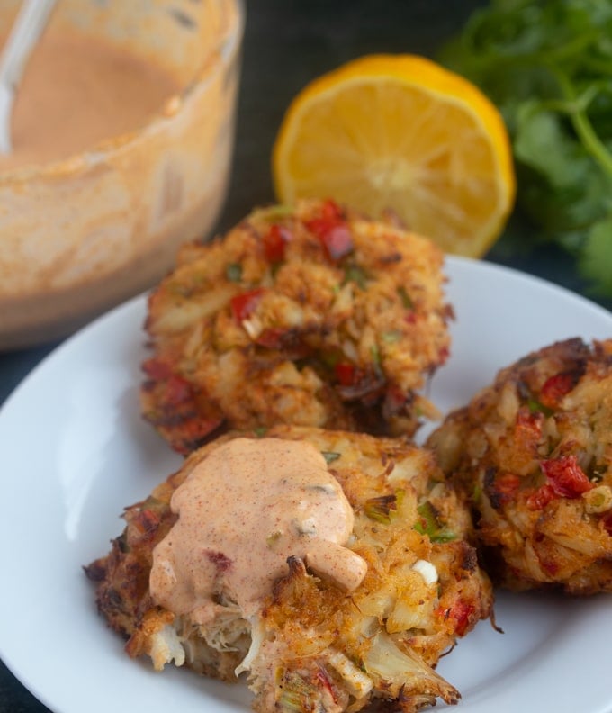 crab cake on a plate with remeloude sauce on top