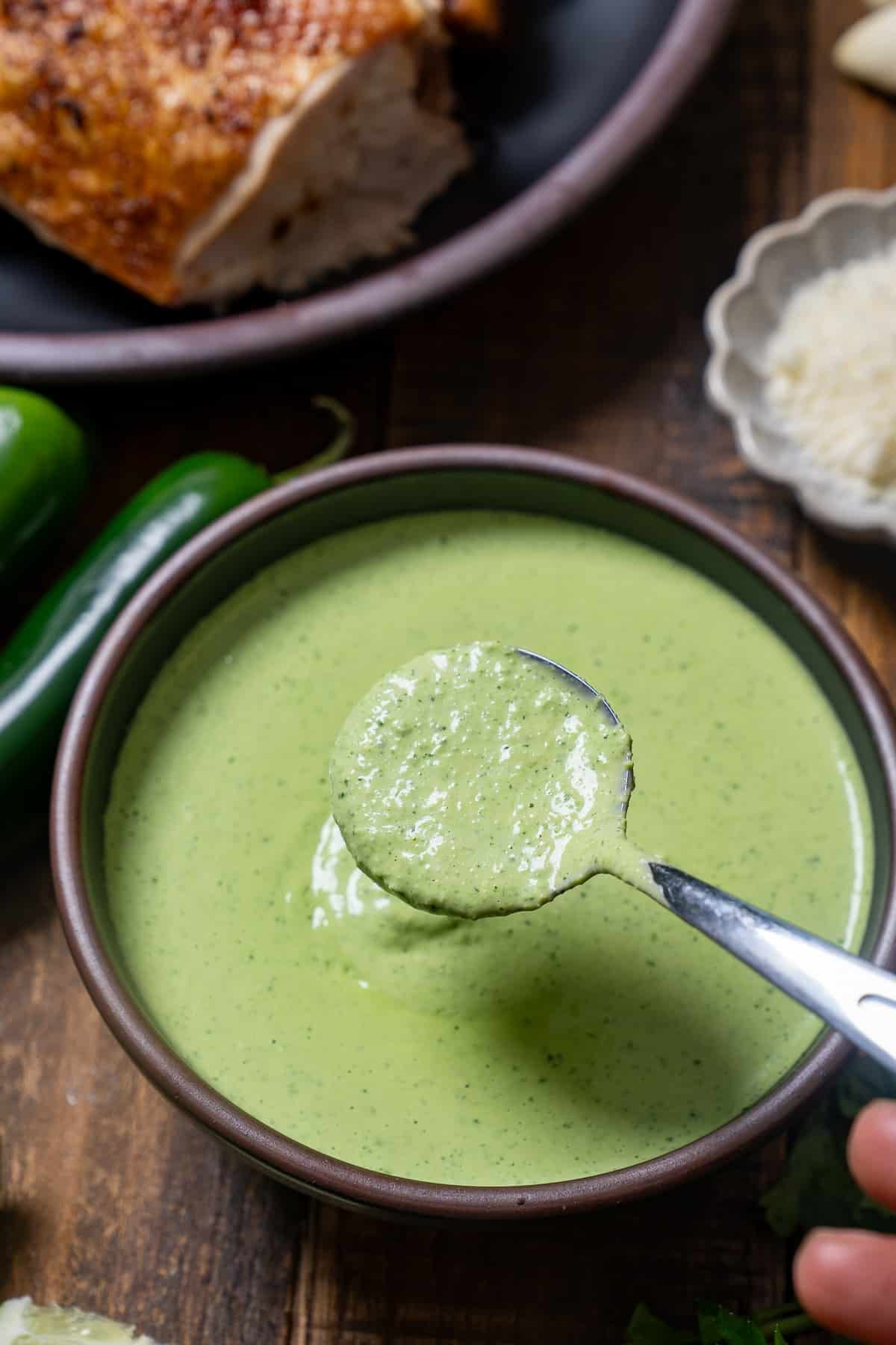 spoon picking up green sauce