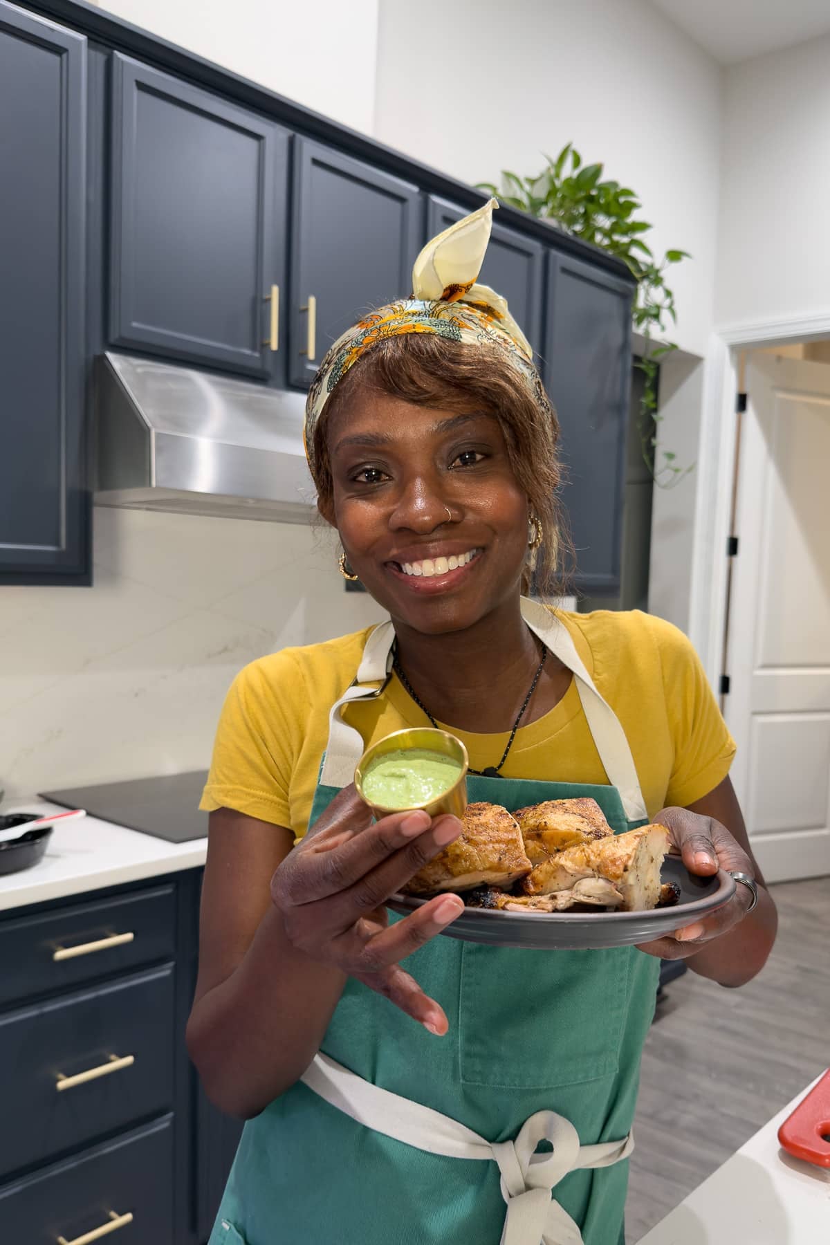 Tanya holding chicken and green sauce