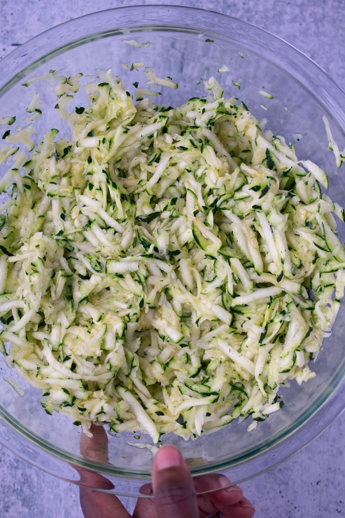 grated zucchini in glass bowl