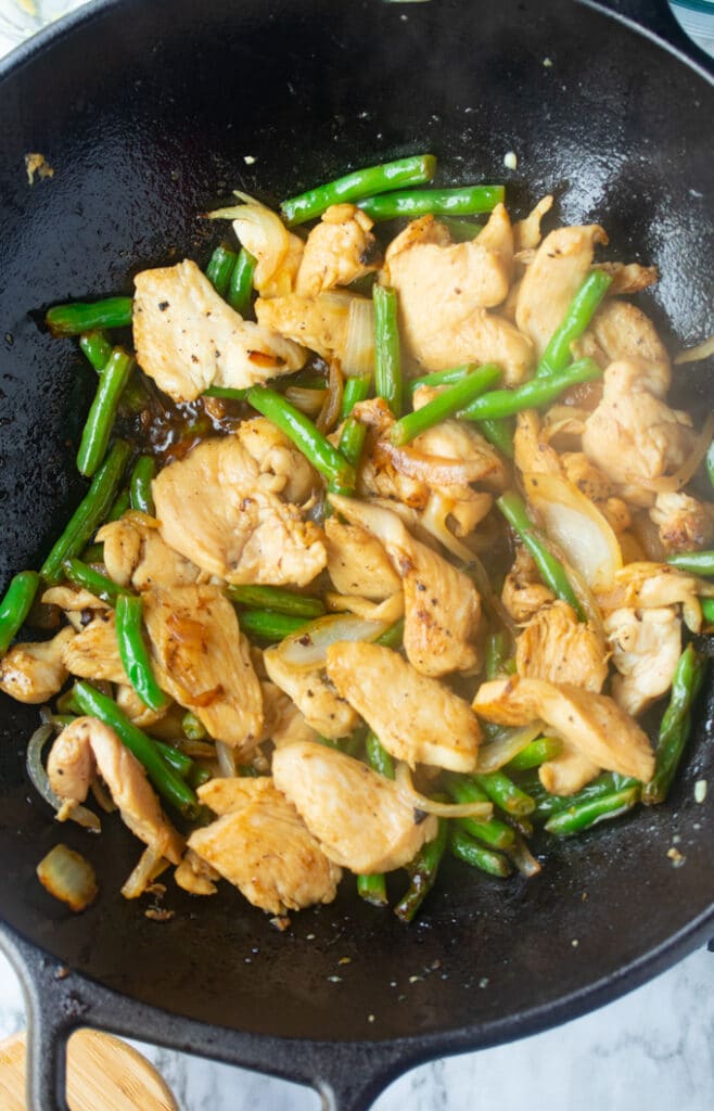 chicken and green bean stir fry in wok