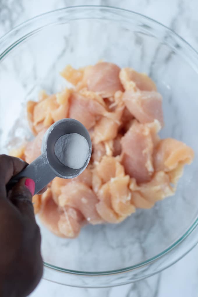 baking soda over raw chicken breast slices