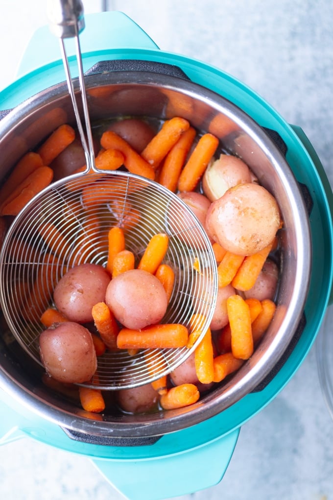 strainer removing vegetables fron instant pot