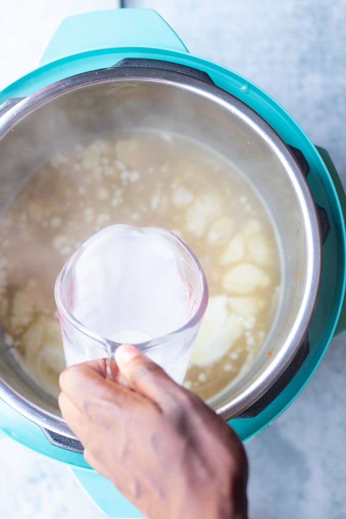 cream being poured into chicken broth