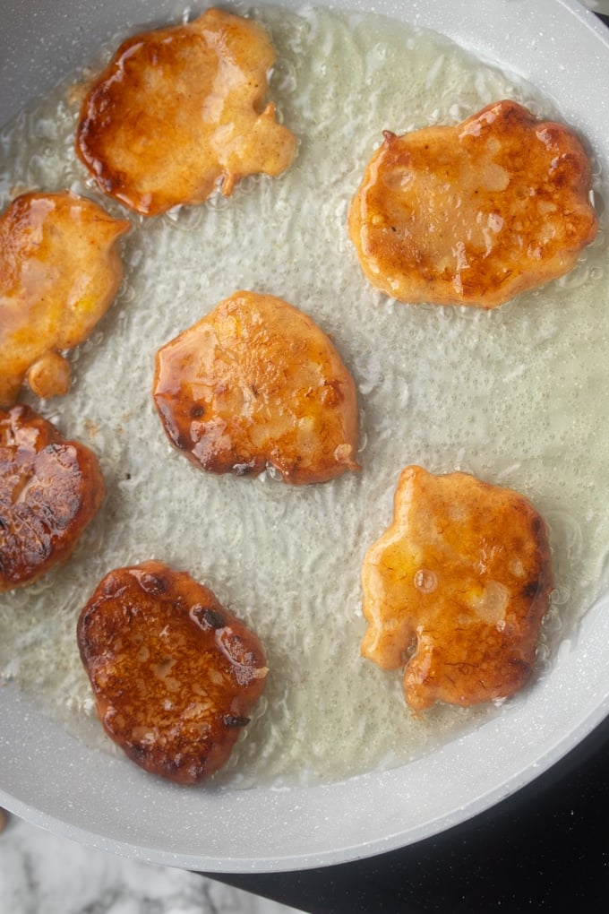 banana fritters frying in oil