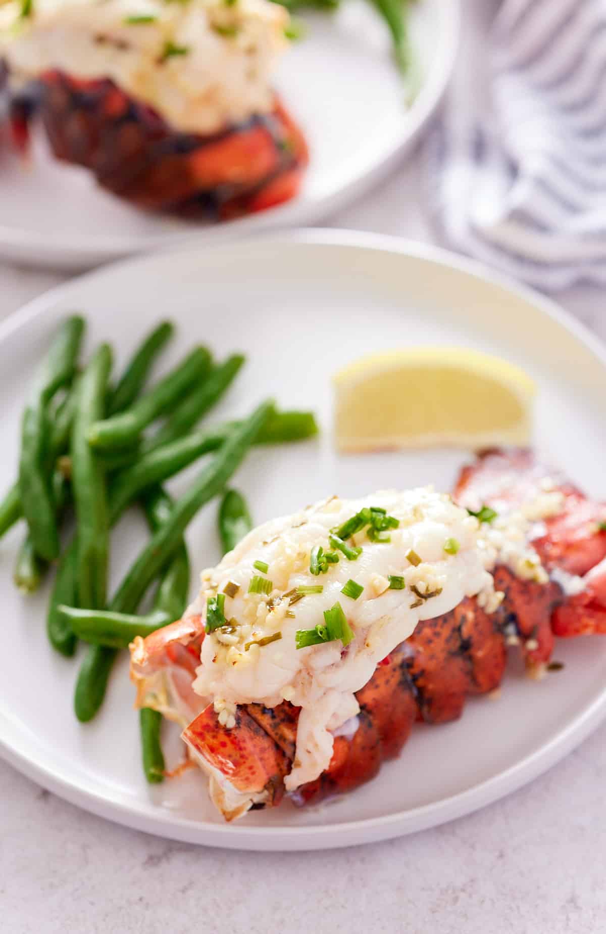 close up photo of lobster tail in air fryer basket