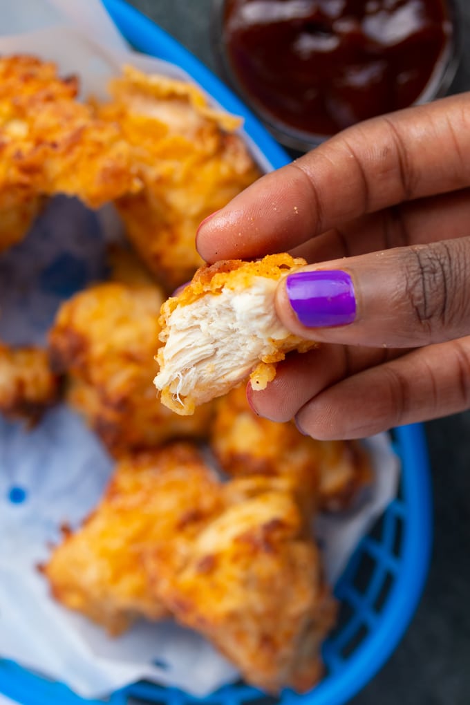 hand holding air fryer chicken nugget showing inside of nugget