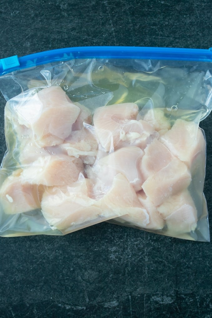 raw chicken pieces in clear bag with pickle juice