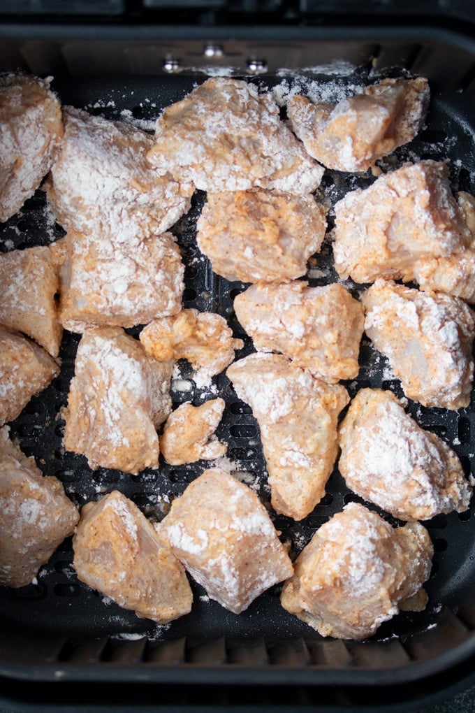 air fryer chicken pieces in air fryer basket before cooking