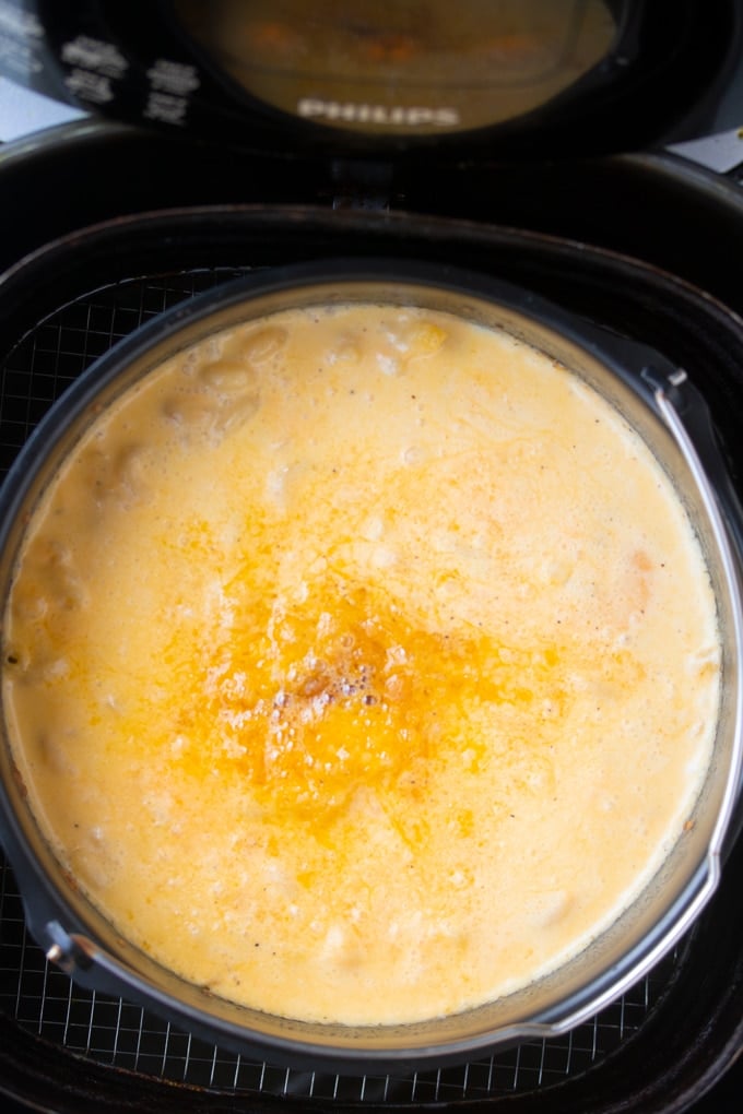 Mac and cheese in air fryer basket before stirring