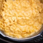 close up photo of mac and cheese in pan in air fryer basket
