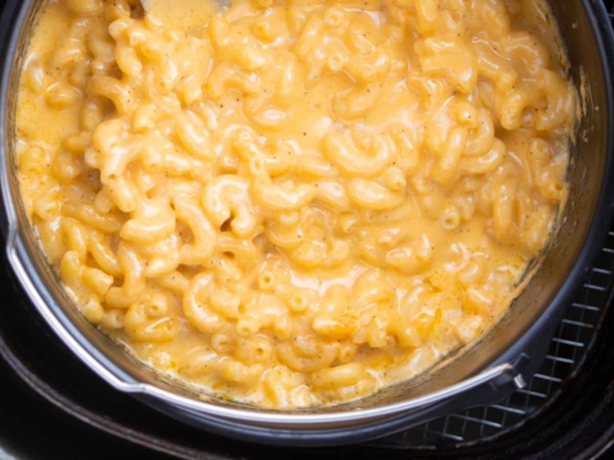close up photo of mac and cheese in pan in air fryer basket