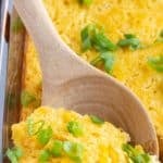 corn souffle in baking dish with spoon picking it up
