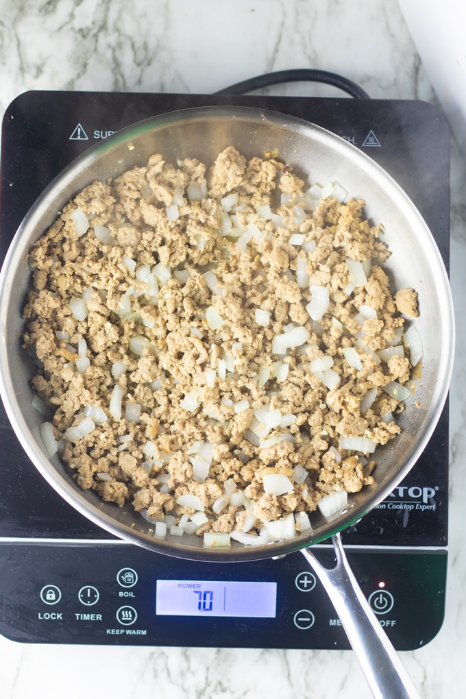 ground turkey in stainless steel skillet 