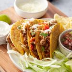 ground turkey tacos in hard shells topped with cheese and cilantro