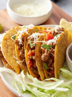 ground turkey tacos in hard shells topped with cheese and cilantro