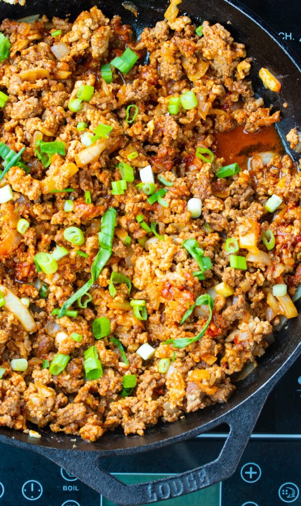 Korean sloppy joes in a skillet with green onions on top