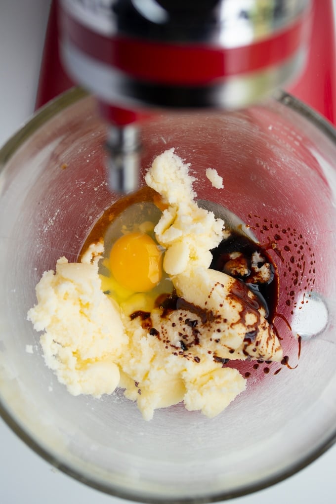 butter in mixing bowl with egg, sugar, vanilla extract, and molasses