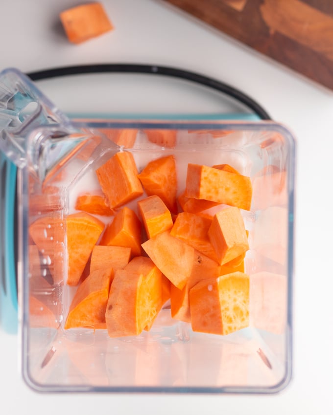 sweet potato chunks in bender with coconut milk on bottom