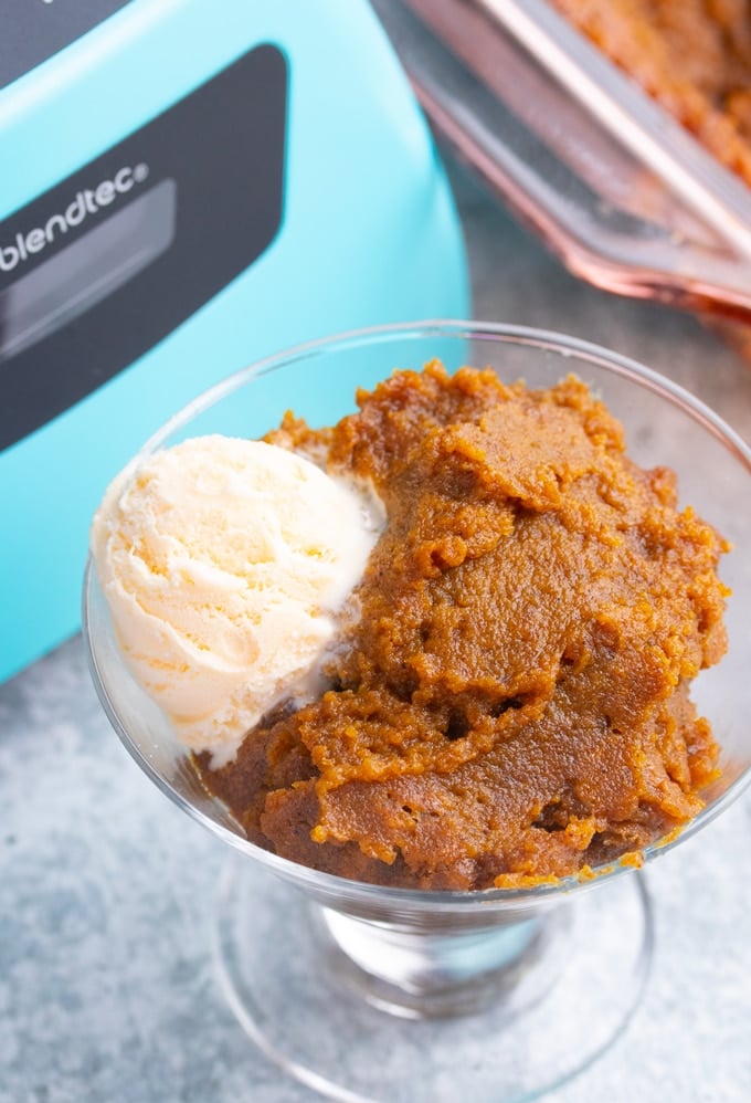 sweet potato pudding in glass jar with a scoop of ice cream in front of blender