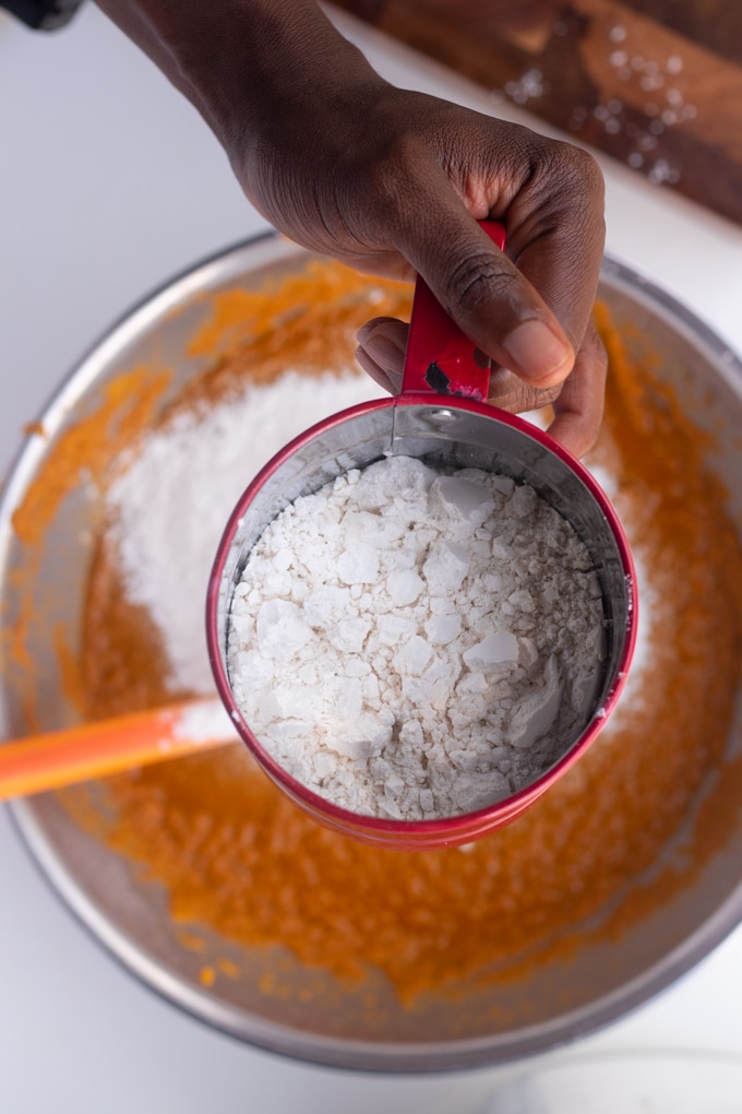 flour sifter over bowl of sweet potato puree