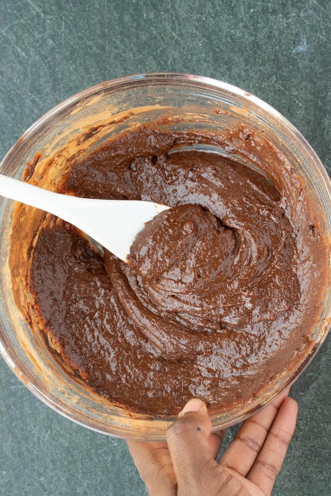 brownie batter in bowl with spoon sticking out