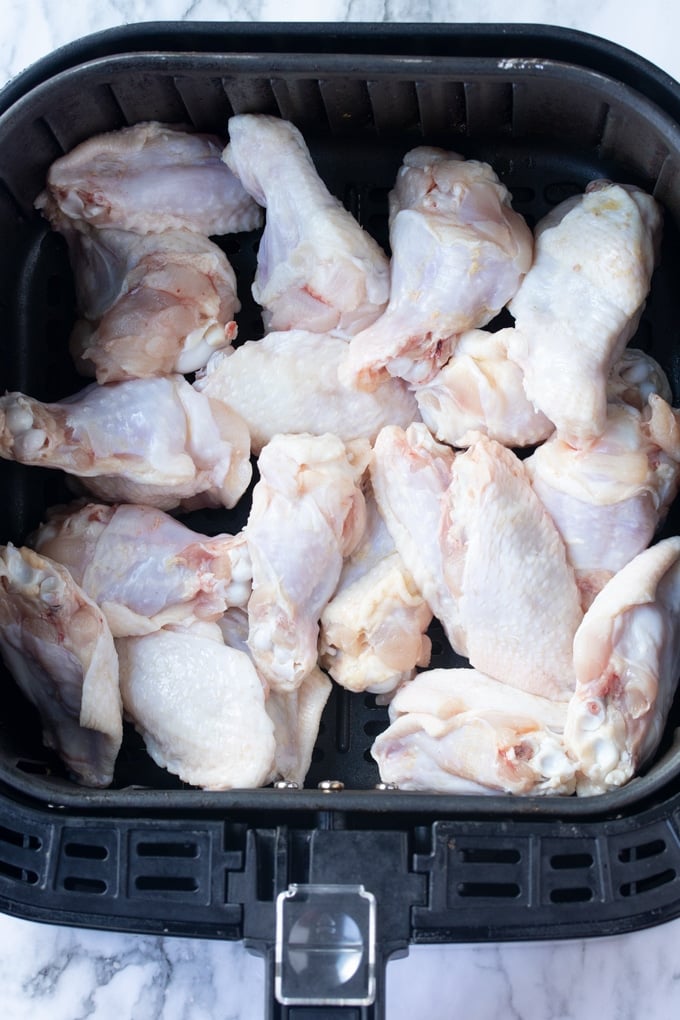 raw chicken wings in air fryer basket