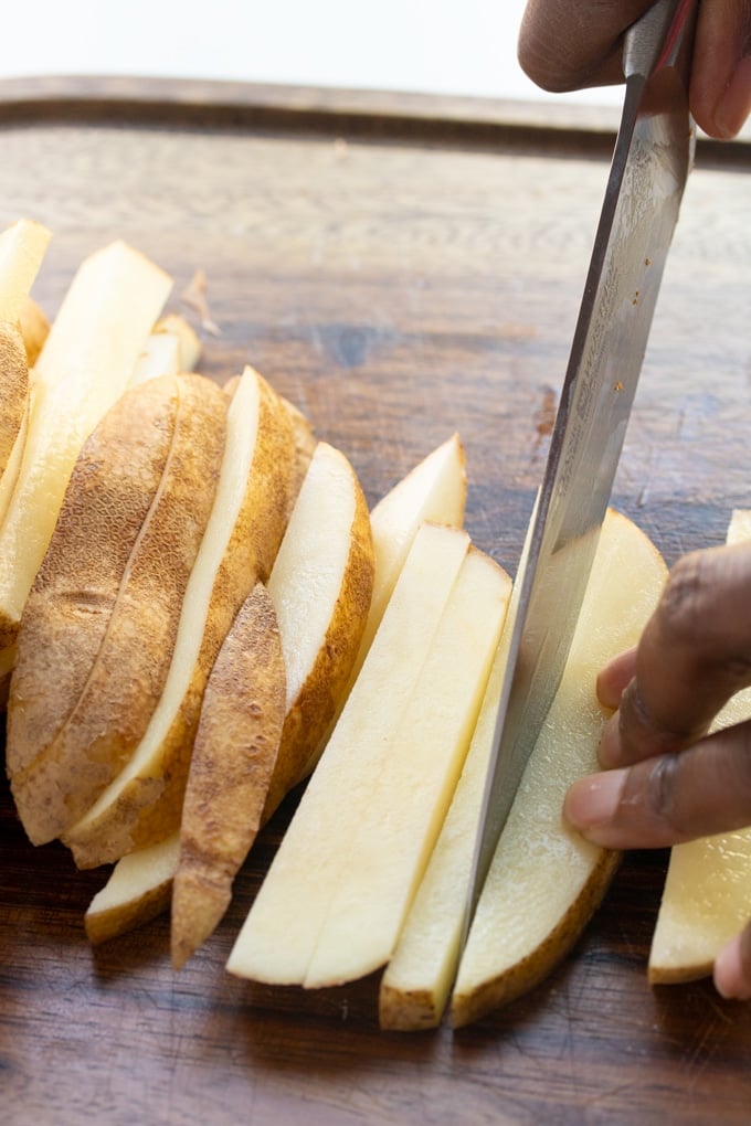 knife cutting potato