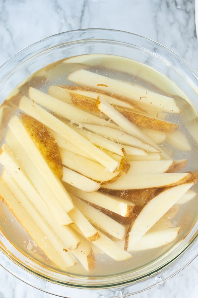 cut fries in bowl of water