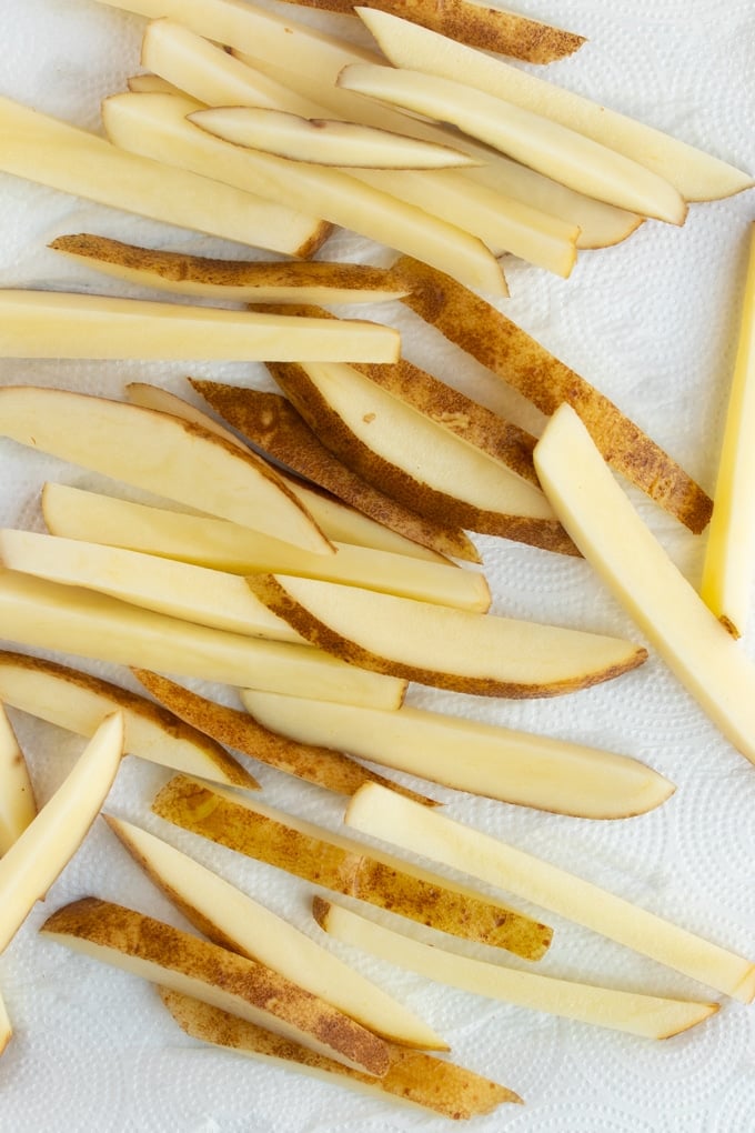 cut fries drying on paper towel