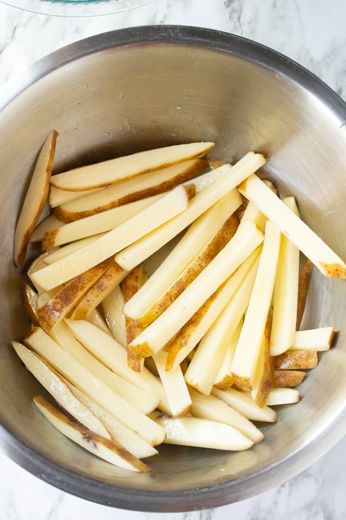cut fries in bowl in oil