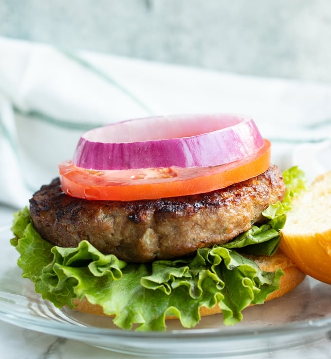 air fryer turkey burger on bread with lettuce, tomato, and onion