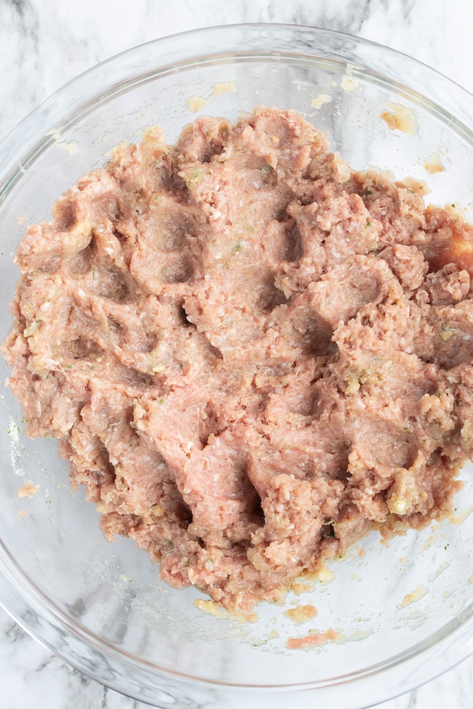 ingredients for turkey burger mixed up in bowl