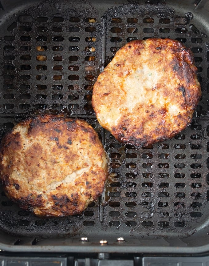 cooked air fryer turkey burgers in air fryer basket