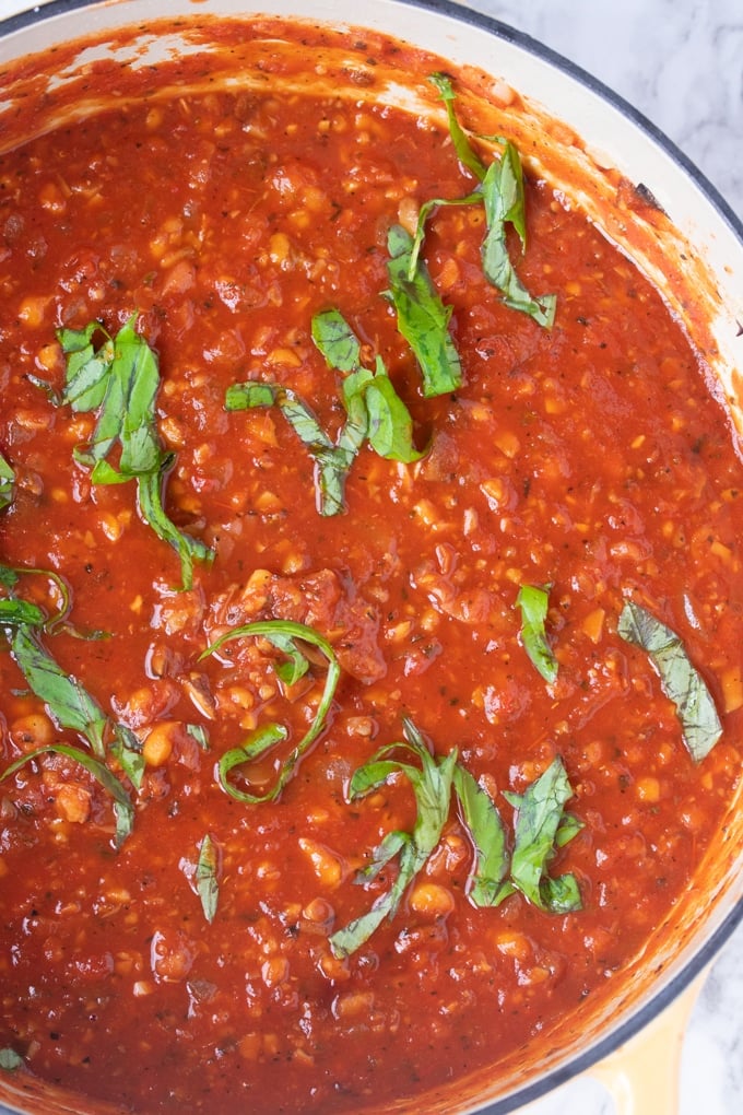 vegetarian spaghetti sauce in pot with basil on top
