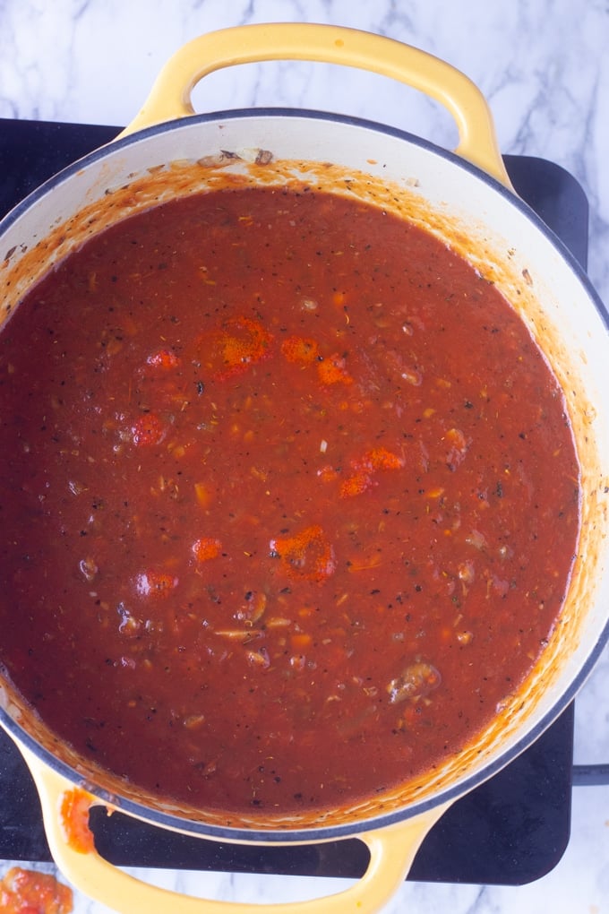 vegetarian spaghetti sauce in yellow pot cooking.