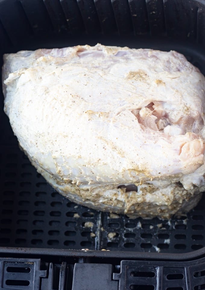 raw turkey breast in air fryer basket