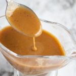 spoon lifting gravy out of gravy dish