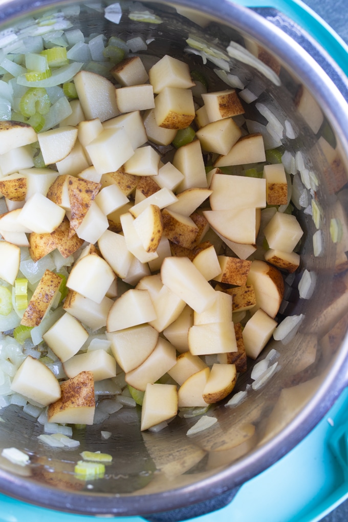 celery, onions, and potato in instant pot insert